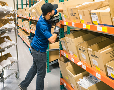 guy grabbing supplies to fill orders